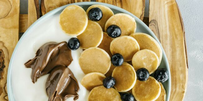Bowl de mini-pancakes yaourt pâte à tartiner et myrtilles